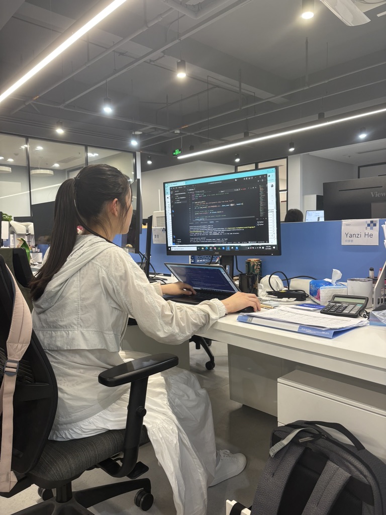Angela writing code at her workstation at Ronovo Surgical